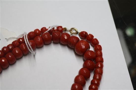 A single strand graduated facetted coral bead necklace, 69cm.